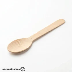 Birchwood wooden spoon placed in a colorful ice cream dessert bowl with gummy bears and candies — eco-friendly cutlery by PackagingBox.pk