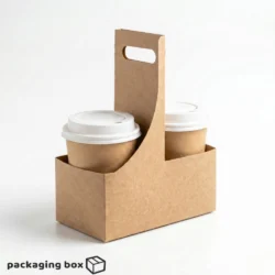Kraft paper disposable cup carrier with handle holding two coffee cups with white lids, displayed on white background — eco-friendly 2 cup takeaway holder by Packaging Box Pakistan