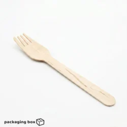 Eco-friendly wooden fork placed in a cheesy baked pasta bowl with vegetables — sustainable disposable cutlery by PackagingBox.pk