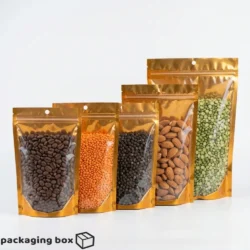 Front transparent copper gold aluminium standup pouch with coffee beans lentils peppercorns almonds and green peas
