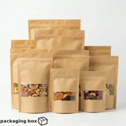 Brown kraft standup pouches in multiple sizes with clear window showing mixed nuts, dried fruits and trail mix – eco-friendly resealable food packaging bags
