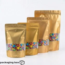 Matt Golden Standing Pouches with Window in 4 sizes filled with colourful candies by Packaging Box Pakistan