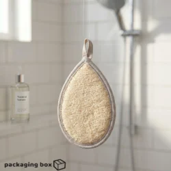 Hand holding a natural teardrop bath loofah scrubbing soapy lather on shoulder in shower with natural serum bottle in background