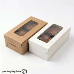 Two 2-piece brownie boxes side by side β kraft brown and white β each with a clear rectangular window showing fudgy brownies inside