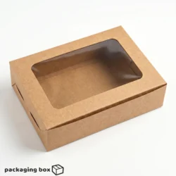Kraft brown 6-piece brownie box with large rectangular clear window showing 6 fudgy salted caramel chocolate chunk brownies, styled with caramel sauce, sea salt and chocolate pieces