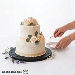 Black Cake Drum Board supporting a 2-tier white fondant wedding cake with blush roses and eucalyptus