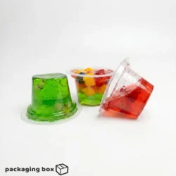Choc Dip Jelly Cup in three variants — green kiwi jelly, mixed tropical fruit jelly with flat lid, and red strawberry jelly tilted — by PackagingBox.pk