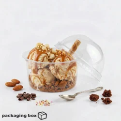Clear disposable dessert cup with lid filled with caramel ice cream scoops, nuts, chocolate and cookie crumble β available at PackagingBox.pk