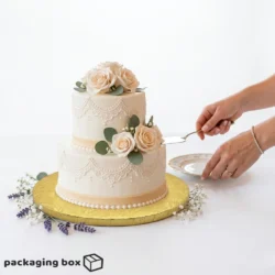 Golden Cake Drum Board supporting a 2-tier white fondant wedding cake with blush roses