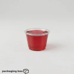 Clear disposable jelly cup filled with red fruit jelly by PackagingBox.pk